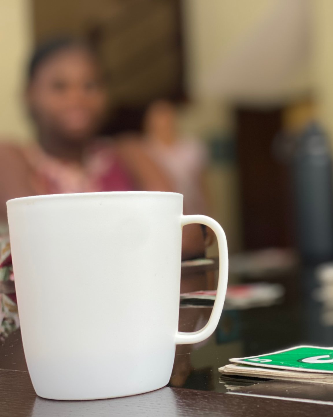 A mug and UNO cards on a table during a quiet family moment at Lifehouse
